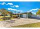 House with brick paver driveway and green lawn at 1296 W Wellington Dr, Deltona, FL 32725