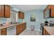 Kitchen with wood cabinets, stainless steel appliances, and light blue walls at 1296 W Wellington Dr, Deltona, FL 32725