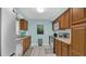 Kitchen with wood cabinets, stainless steel appliances, and light blue walls at 1296 W Wellington Dr, Deltona, FL 32725