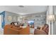 Living room with orange couch, brown chairs, and built in shelves at 1296 W Wellington Dr, Deltona, FL 32725