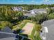 Community aerial view of a sand volleyball court and townhome buildings at 130 Southern Pecan Cir # 102, Winter Garden, FL 34787