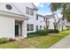 Townhome community featuring light-colored buildings and landscaping at 130 Southern Pecan Cir # 102, Winter Garden, FL 34787