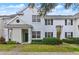 Two story townhome with light beige siding and dark green door at 130 Southern Pecan Cir # 102, Winter Garden, FL 34787