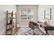 Bright home office features modern desk, chair, ladder shelving, and a window offering natural light at 130 Southern Pecan Cir # 102, Winter Garden, FL 34787