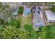 Aerial view showcasing a charming teal house with a spacious backyard at 1300 E Kaley St, Orlando, FL 32806