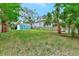 Expansive grassy backyard with mature trees and a shed at 1300 E Kaley St, Orlando, FL 32806