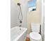 Clean bathroom with gray tile, white toilet and bathtub at 1300 E Kaley St, Orlando, FL 32806