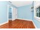 Light blue bedroom with hardwood floors and closet at 1300 E Kaley St, Orlando, FL 32806