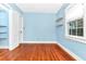 Light blue bedroom with hardwood floors and closet at 1300 E Kaley St, Orlando, FL 32806