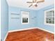 Light blue bedroom with hardwood floors and built-in shelves at 1300 E Kaley St, Orlando, FL 32806