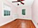 Pink bedroom with hardwood floors, ceiling fan and dresser at 1300 E Kaley St, Orlando, FL 32806