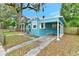 Light blue house with carport and a spacious yard at 1300 E Kaley St, Orlando, FL 32806