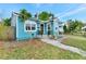 Cute light blue house with a walkway and well-maintained lawn at 1300 E Kaley St, Orlando, FL 32806