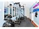 Well-equipped home gym featuring weight machine, mirrors, and mats at 1300 E Kaley St, Orlando, FL 32806