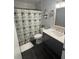 Clean bathroom with shower, white vanity, and playful decor at 13029 Cog Hill Way, Orlando, FL 32828