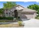 Two-story house with brick and beige siding at 13029 Cog Hill Way, Orlando, FL 32828