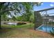 Screened-in pool and patio area, overlooking a pond at 13029 Cog Hill Way, Orlando, FL 32828