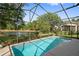 Relaxing screened-in pool with pond view at 13029 Cog Hill Way, Orlando, FL 32828