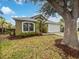 House exterior showcases a large tree and manicured landscaping at 142 Brushcreek Dr, Sanford, FL 32771