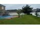 Backyard with pool and grassy area at 14324 Fieldstone Lake Way, Orlando, FL 32824