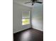 Spacious bedroom with dark wood flooring and a large window at 14324 Fieldstone Lake Way, Orlando, FL 32824