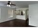 Bright dining room with dark hardwood floors and kitchen access at 14324 Fieldstone Lake Way, Orlando, FL 32824