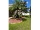 Landscaped front yard with palm trees and mulch beds at 14324 Fieldstone Lake Way, Orlando, FL 32824