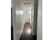 Bright hallway with dark hardwood floors and neutral walls at 14324 Fieldstone Lake Way, Orlando, FL 32824