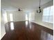 Large living room with hardwood floors and lots of natural light at 14324 Fieldstone Lake Way, Orlando, FL 32824