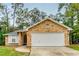 Brick house with a two-car garage and a well-manicured lawn at 1501 Red Oak Ct, Apopka, FL 32703