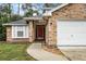 Brick house with red front door and attached two-car garage at 1501 Red Oak Ct, Apopka, FL 32703