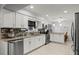 Modern kitchen with white cabinets, granite countertops, and stainless steel appliances at 1501 Red Oak Ct, Apopka, FL 32703