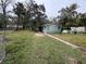 Property view showing house, yard, and surrounding trees at 1504 Laun Pl, Lakeland, FL 33803