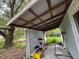 Covered back patio with storage shelving and concrete flooring at 1504 Laun Pl, Lakeland, FL 33803