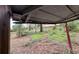 Damaged carport with overgrown vegetation in the background at 1504 Laun Pl, Lakeland, FL 33803