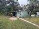 Cute bungalow with painted mural and covered carport at 1504 Laun Pl, Lakeland, FL 33803