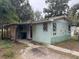 Quaint light blue house with sunflower mural and covered patio at 1504 Laun Pl, Lakeland, FL 33803