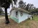 Side view of a small light teal house at 1504 Laun Pl, Lakeland, FL 33803