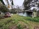 Back view of a house with overgrown yard at 1504 Laun Pl, Lakeland, FL 33803