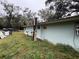 Side view of a light blue house needing some repairs at 1504 Laun Pl, Lakeland, FL 33803