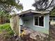 Another view of the house exterior showing overgrown vegetation at 1504 Laun Pl, Lakeland, FL 33803