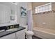 Clean bathroom, featuring a soaking tub, granite countertop, and a large mirror at 1549 Corolla Ct, Reunion, FL 34747