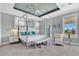 Luxurious Primary bedroom with a king-size bed, sitting area, and water views at 1549 Corolla Ct, Reunion, FL 34747