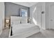 Bright bedroom with a white platform bed and gray walls at 1549 Corolla Ct, Reunion, FL 34747