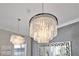 Close-up of crystal chandelier in dining area at 1549 Corolla Ct, Reunion, FL 34747