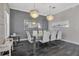 Spacious dining area with a large glass table and modern chandelier at 1549 Corolla Ct, Reunion, FL 34747