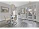 Bright dining room with glass table, white chairs, and modern chandelier at 1549 Corolla Ct, Reunion, FL 34747