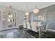 Elegant dining room featuring a large glass table and crystal chandelier at 1549 Corolla Ct, Reunion, FL 34747
