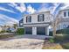 Two-story house with a two car garage and brick driveway at 1549 Corolla Ct, Reunion, FL 34747