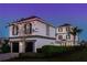 Stunning two-story home with gray accents and a two-car garage at 1549 Corolla Ct, Reunion, FL 34747